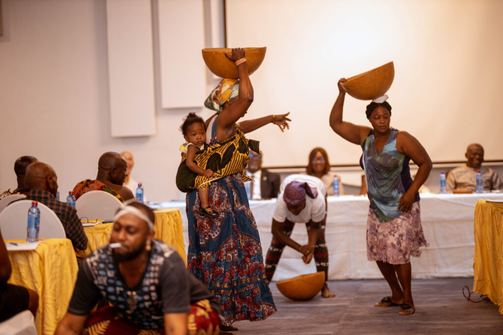 A cultural group illustrating  how  open defecation and indiscriminate disposal of waste products into water sources contaminate water during the Assurance Fund Launch.